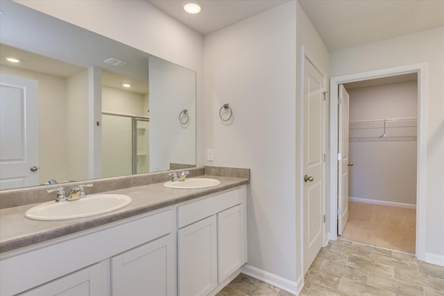 6093 Whitewater Dr, North Augusta, SC 29841 - bathroom with a stall shower, double vanity, a spacious closet, and recessed lighting