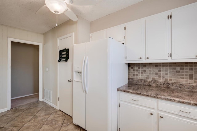 kitchen with white cabinetry, decorative backsplash, white fridge with ice dispenser, and ceiling fan