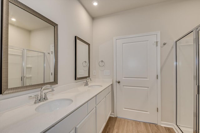 bathroom with vanity, wood-type flooring, and walk in shower