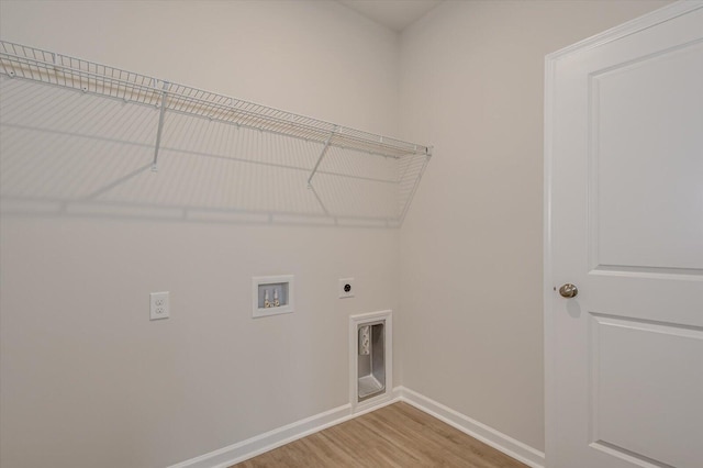 washroom featuring hardwood / wood-style flooring, washer hookup, and hookup for an electric dryer