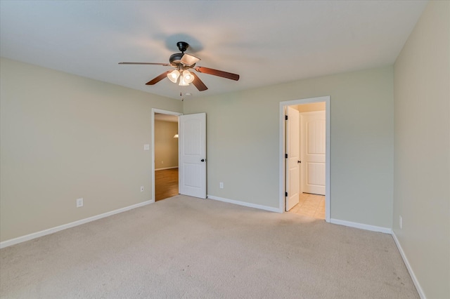 unfurnished bedroom with ceiling fan, baseboards, and light carpet