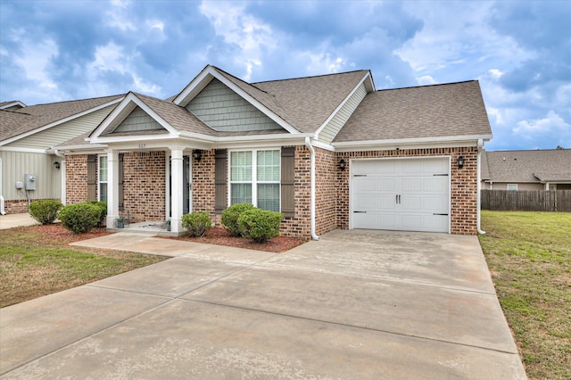 ranch-style home featuring fence, a shingled roof, an attached garage, and brick siding