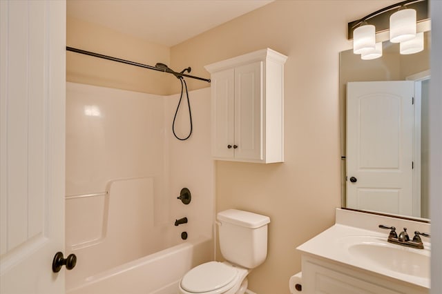bathroom featuring toilet, washtub / shower combination, vanity, and baseboards