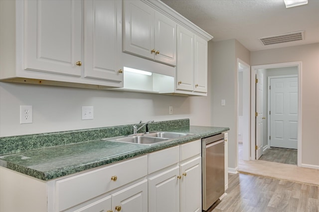 1869 Heathers Way, Augusta, GA 30906 - kitchen with stainless steel dishwasher, light wood finished floors, a sink, dark countertops, and white cabinetry