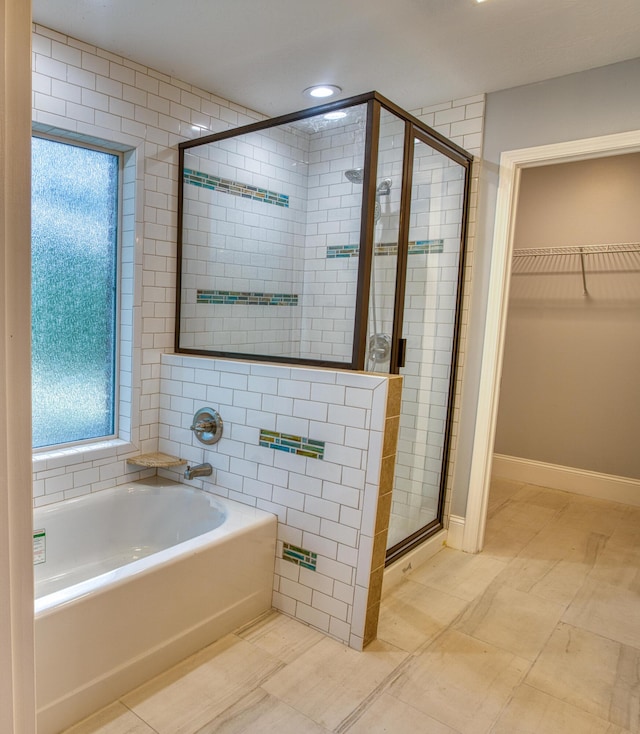 1423 Edgefield Rd, North Augusta, SC 29860 - bathroom with a bath, a shower stall, a walk in closet, and recessed lighting