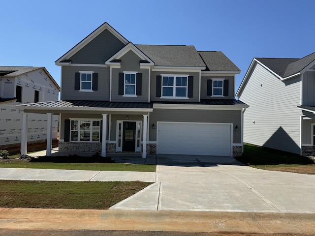 view of front of house featuring covered porch and a garage