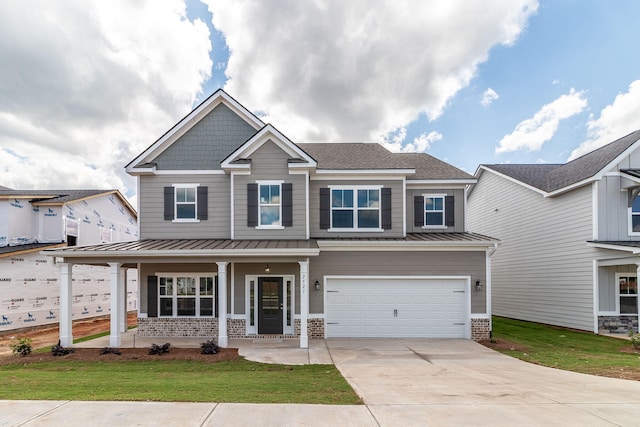 craftsman-style home with a porch, a garage, and a front yard