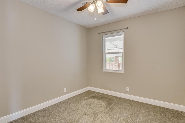 empty room featuring ceiling fan, carpet floors, and a textured ceiling