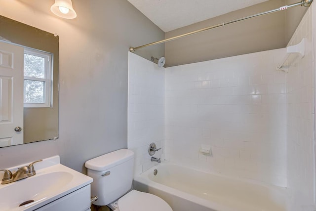 full bathroom with tiled shower / bath, vanity, and toilet