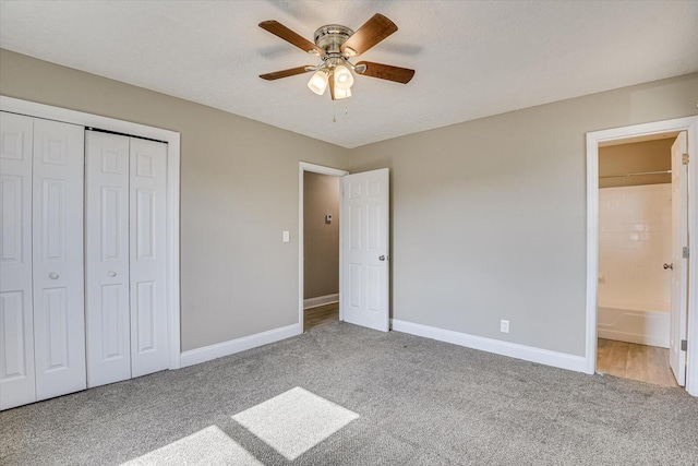 unfurnished bedroom with ceiling fan, a closet, ensuite bathroom, and light carpet