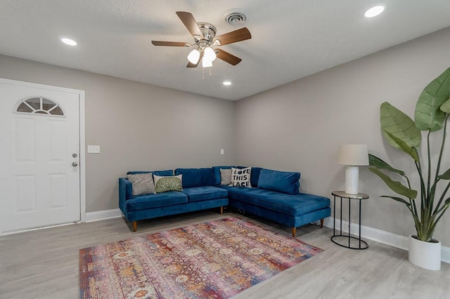 living room featuring ceiling fan and light wood-type flooring