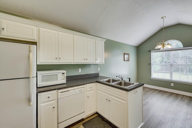 198 Eagle Lake Rd, North Augusta, SC 29841 - kitchen with white appliances, vaulted ceiling, dark countertops, white cabinets, and wood finished floors