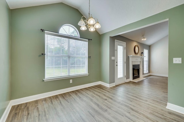 198 Eagle Lake Rd, North Augusta, SC 29841 - unfurnished living room with lofted ceiling, a chandelier, wood finished floors, and a fireplace