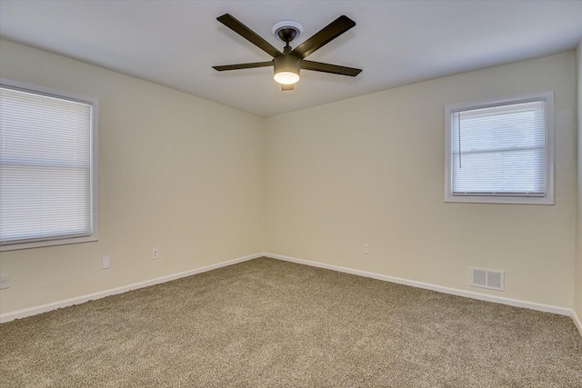 unfurnished room featuring ceiling fan, baseboards, visible vents, and carpet floors