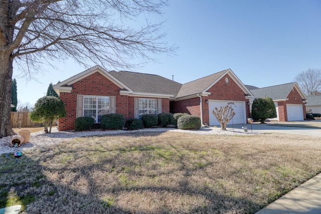 single story home with a front yard and a garage