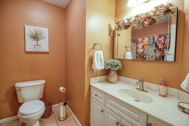 bathroom with toilet, tile patterned floors, and vanity