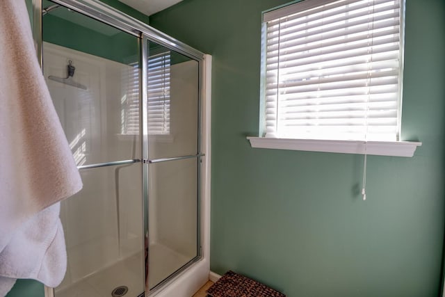 bathroom with a shower with shower door