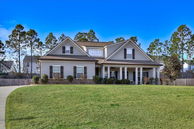 view of front of house with covered porch and a front lawn