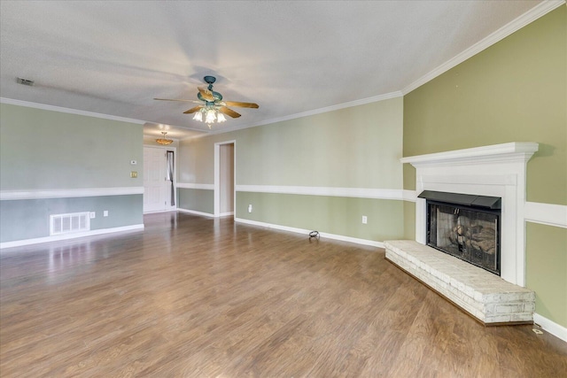 unfurnished living room featuring ceiling fan, wood-type flooring, a textured ceiling, and ornamental molding