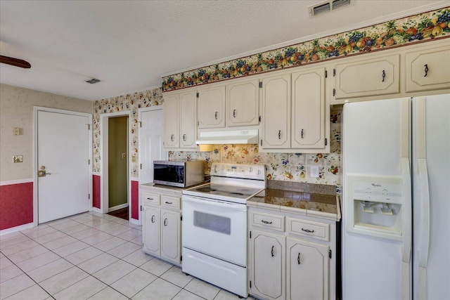 kitchen with white appliances and light tile patterned floors