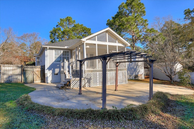 rear view of house featuring a sunroom, a pergola, and a patio