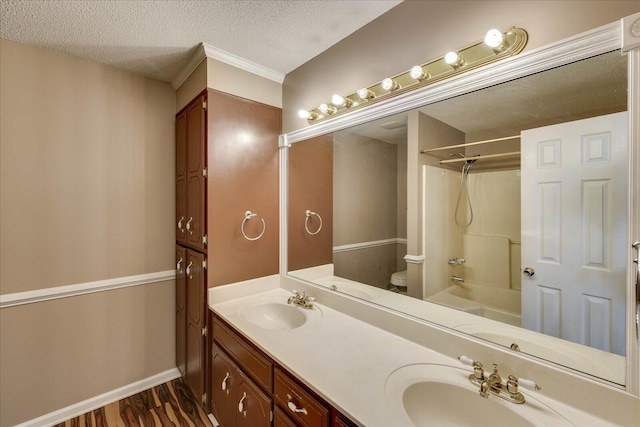 full bathroom with vanity, shower / washtub combination, hardwood / wood-style flooring, toilet, and a textured ceiling