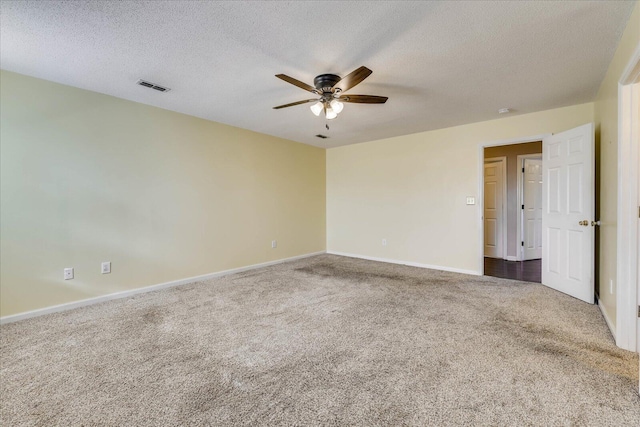 unfurnished room featuring ceiling fan, dark carpet, and a textured ceiling