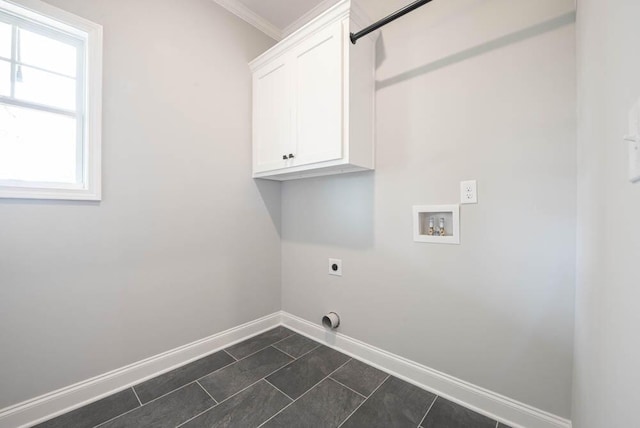 washroom with washer hookup, cabinets, hookup for an electric dryer, dark tile patterned flooring, and ornamental molding