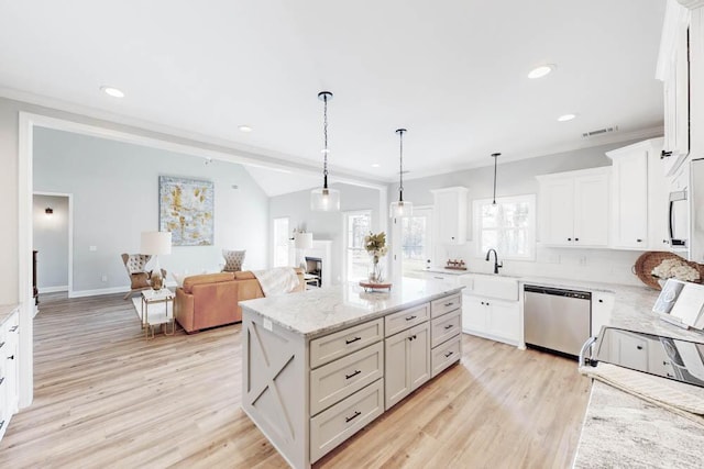 kitchen featuring light stone countertops, dishwasher, hanging light fixtures, a center island, and white cabinets