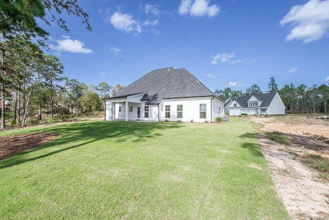 rear view of property with a lawn