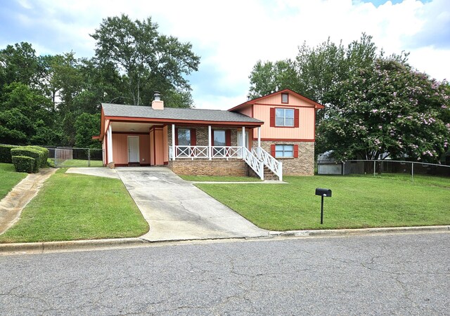 split level home with a front yard and a carport