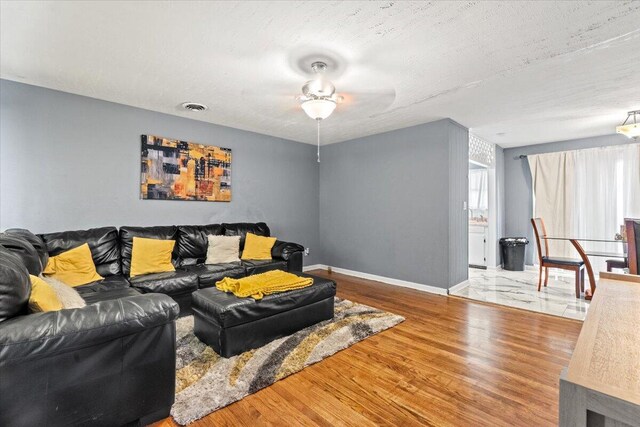3318 Forest Estates Dr, Augusta, GA 30909 - living room with wood finished floors, ceiling fan, baseboards, and a textured ceiling