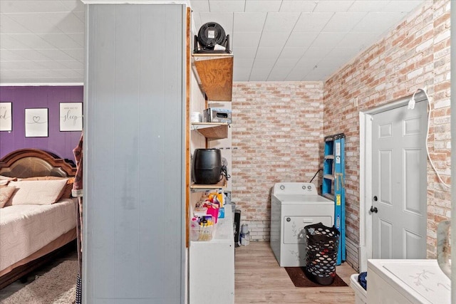 3318 Forest Estates Dr, Augusta, GA 30909 - washroom with washer / clothes dryer, brick wall, and wood finished floors