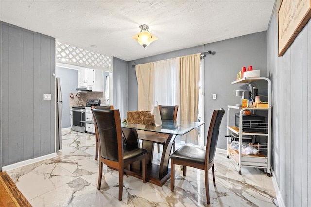 3318 Forest Estates Dr, Augusta, GA 30909 - dining room featuring light marble finish floors, baseboards, wooden walls, and a textured ceiling