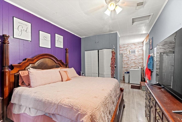 3318 Forest Estates Dr, Augusta, GA 30909 - bedroom featuring light wood-style flooring, crown molding, and brick wall