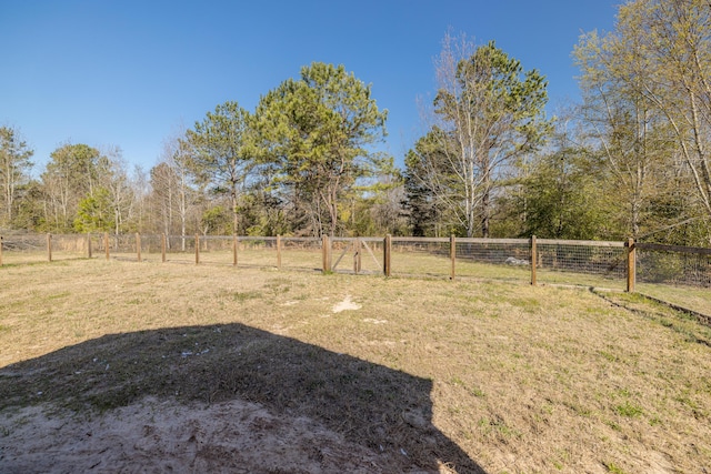 view of yard with a rural view and fence