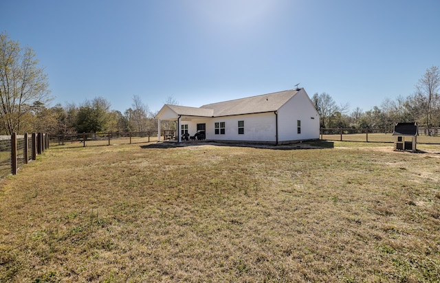 back of house with a patio, a fenced backyard, and a lawn