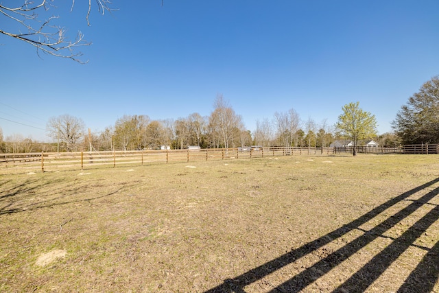 view of yard featuring a rural view and fence