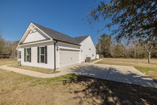 view of side of home with cooling unit, driveway, a yard, and roof with shingles