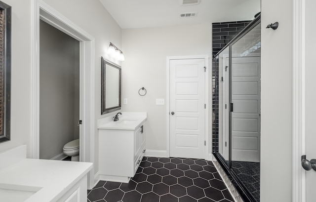 bathroom featuring visible vents, toilet, a stall shower, and vanity