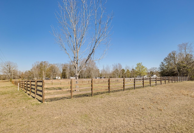 view of yard featuring a rural view and fence