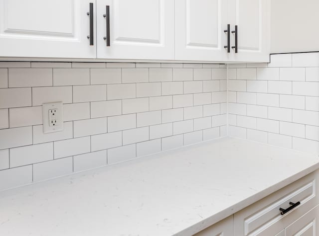 interior details with light stone counters and white cabinetry