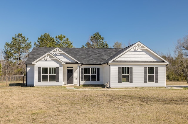 view of front facade featuring a front yard and fence