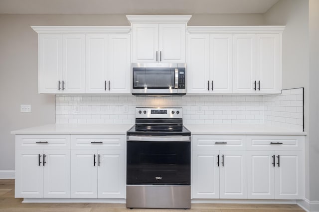 kitchen featuring white cabinetry, light countertops, and stainless steel appliances