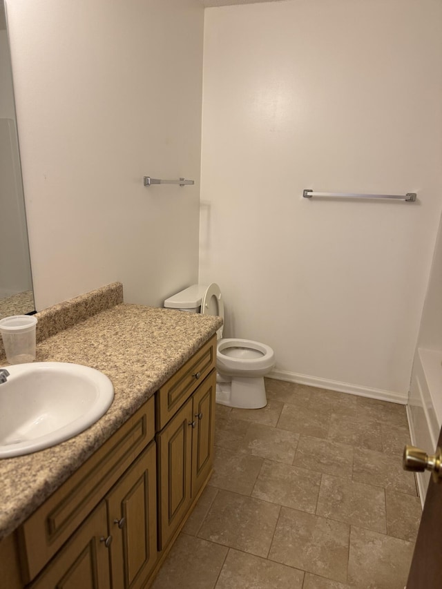 3909 Roberts Rd, Augusta, GA 30907 - bathroom with vanity, toilet, a tub, and baseboards