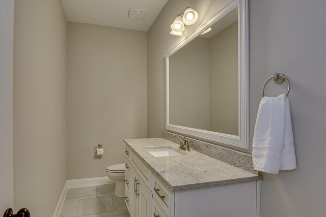 bathroom featuring vanity, tile patterned floors, and toilet