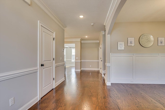 hallway featuring ornamental molding and dark wood-type flooring