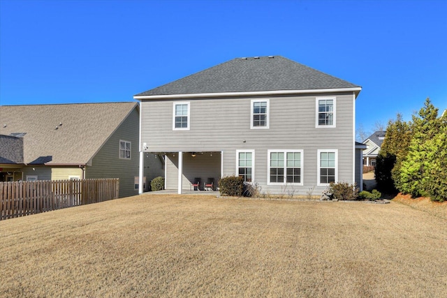 rear view of house with a yard and a patio area