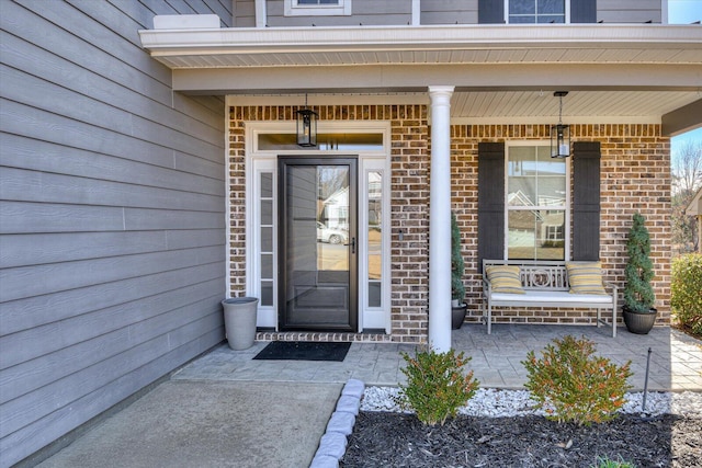 view of exterior entry with a porch