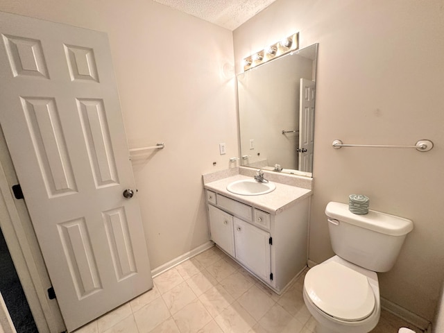 4917 Cavan Pl, Grovetown, GA 30813 - bathroom featuring vanity, toilet, marble look tile flooring, baseboards, and a textured ceiling